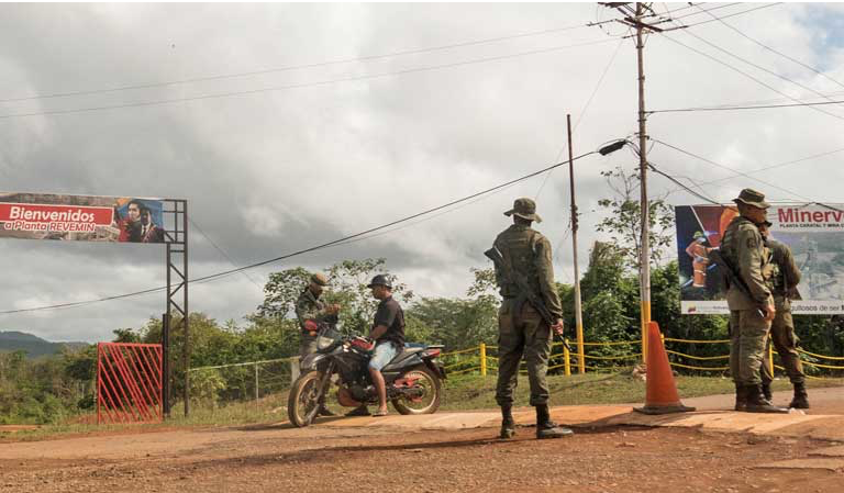 The Venezuelan military stops motorists passing in front of Minerven, a state company just outside of the town of El Callao. These military checkpoints are a regular part of Venezuelan life today. Image by Bram Ebus. Venezuela, 2017.