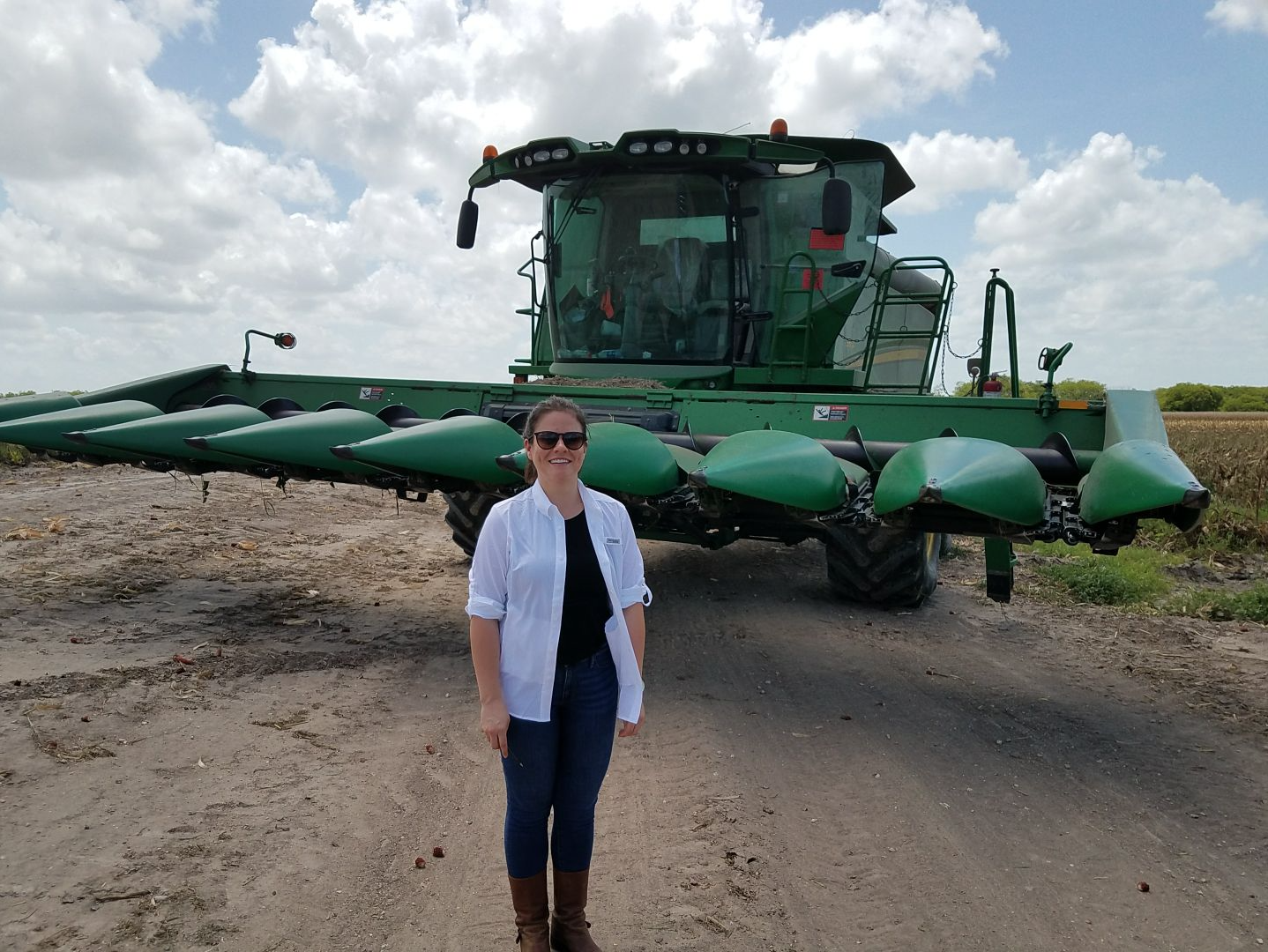 The Texas Tribune’s Kiah Collier poses in front of a combine in the Rio Grande Valley of Texas during a reporting trip for the project. Image by Julián Aguilar. United States, 2017.