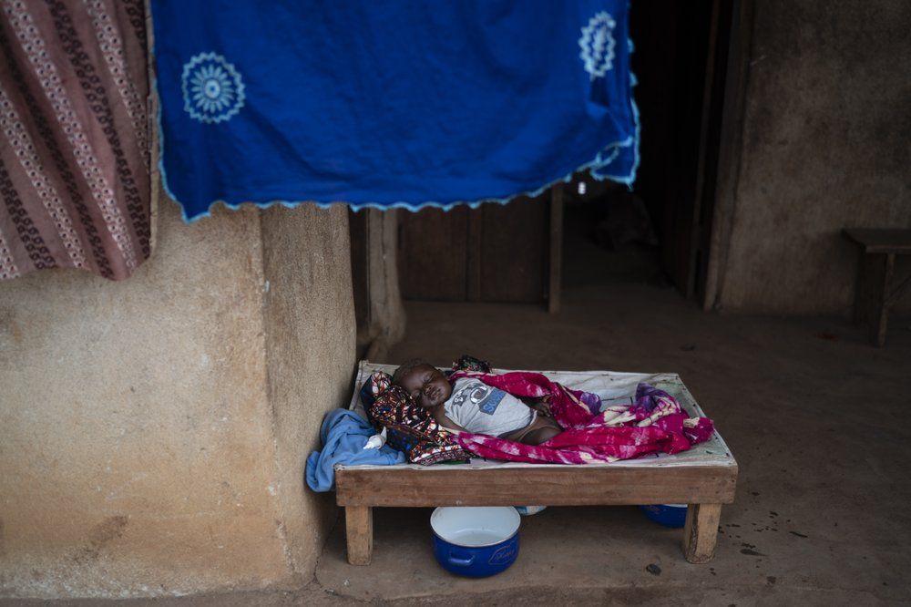 A baby sleeps at the entrance of his house in Komao village, on the outskirts of Koidu, district of Kono, Sierra Leone, Sunday, Nov. 22, 2020. Image by Leo Correa/AP Photo. Sierra Leone, 2020.
.