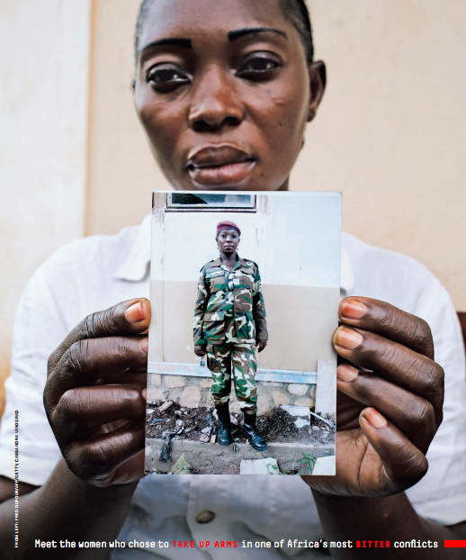 Marie-Yvette, photographed in Bangui on September 24, holds an undated picture of herself in her Séléka uniform. Image by Cassandra Vinograd. Central African Republic, 2017.
