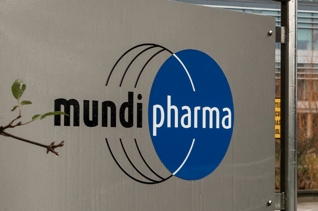 This Dec. 12, 2019, photo shows a sign at the Mundipharma International headquarters at Cambridge Science Park in England. Mundipharma is the international affiliate of Purdue Pharma, the maker of the blockbuster painkiller OxyContin. Mundipharma is now marketing Nyxoid, a new brand of naloxone, an opioid overdose reversal medication. Image by Leila Coker / AP Photo. United Kingdom, 2019.