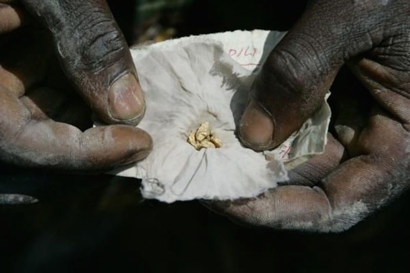 A miner shows off a piece of gold. Image by Carlos Villalon. Democratic Republic of Congo, 2006.