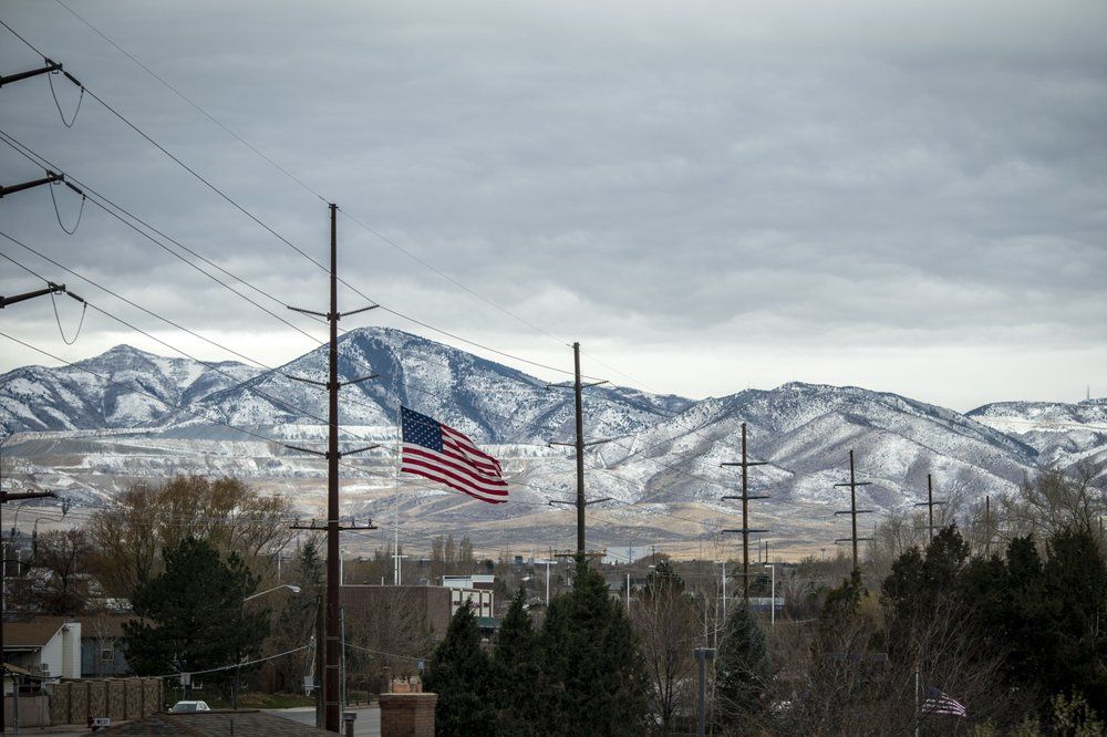 A U.S. flag flies against the mountains in Bountiful, Utah, Sunday, Nov. 15, 2020. Founded by believers in what was then a small, fringe religion, Utah was then lost in the desolation of mountains and deserts, and viewed with suspicion by much of America. The insularity that resulted has been fading over the past few decades, but it's still a place intensely proud of its own distinctiveness. Image by Wong Maye-E / AP Photo. United States, 2020.