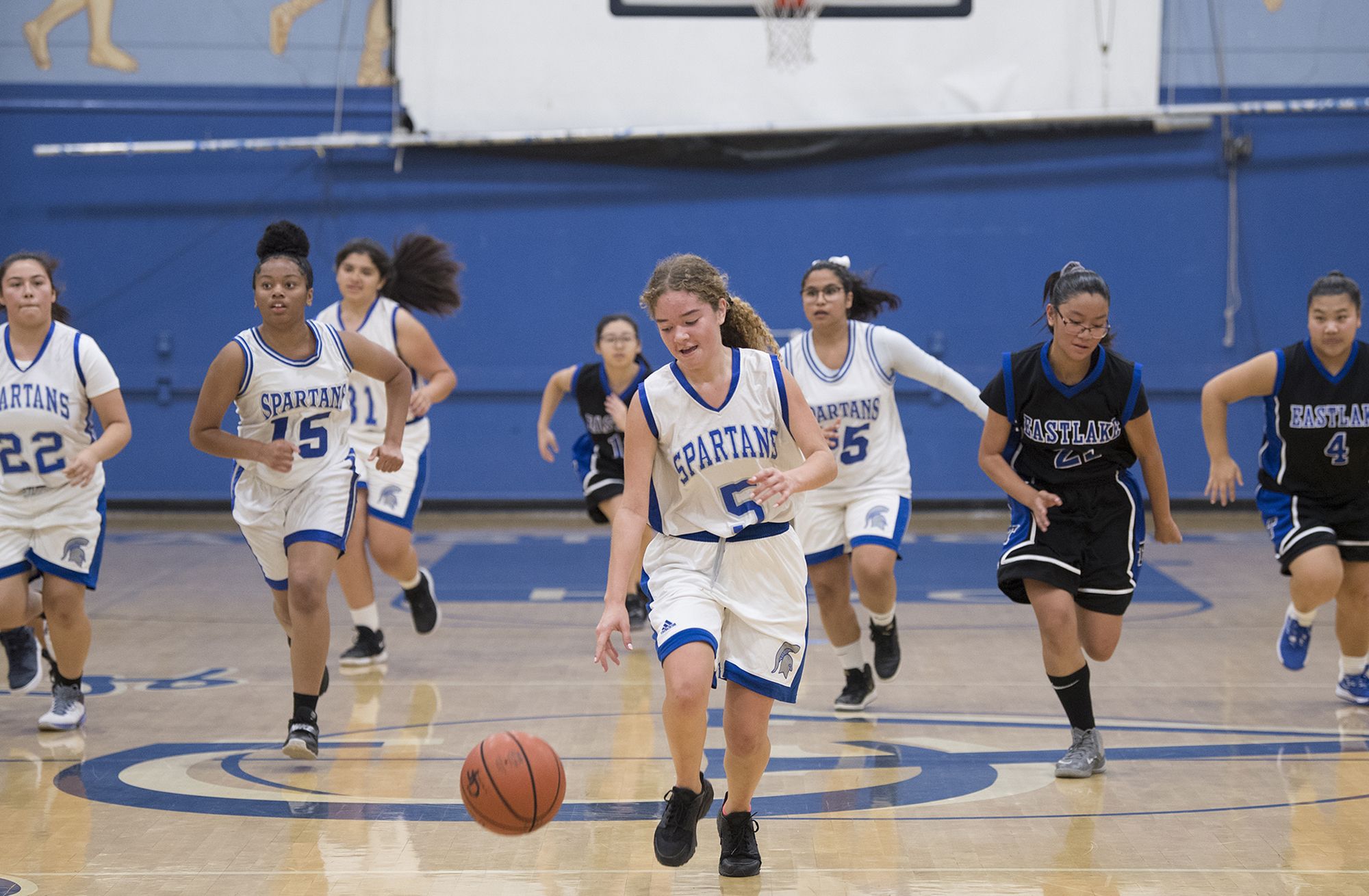 Kennedy Flores with ball, leads a fast break in the first half against Eastlake High School at Chula Vista High School on Nov. 27. Kennedy is one of the captains on the novice girls’ basketball team. Image by Amanda Cowan. United States, 2019.