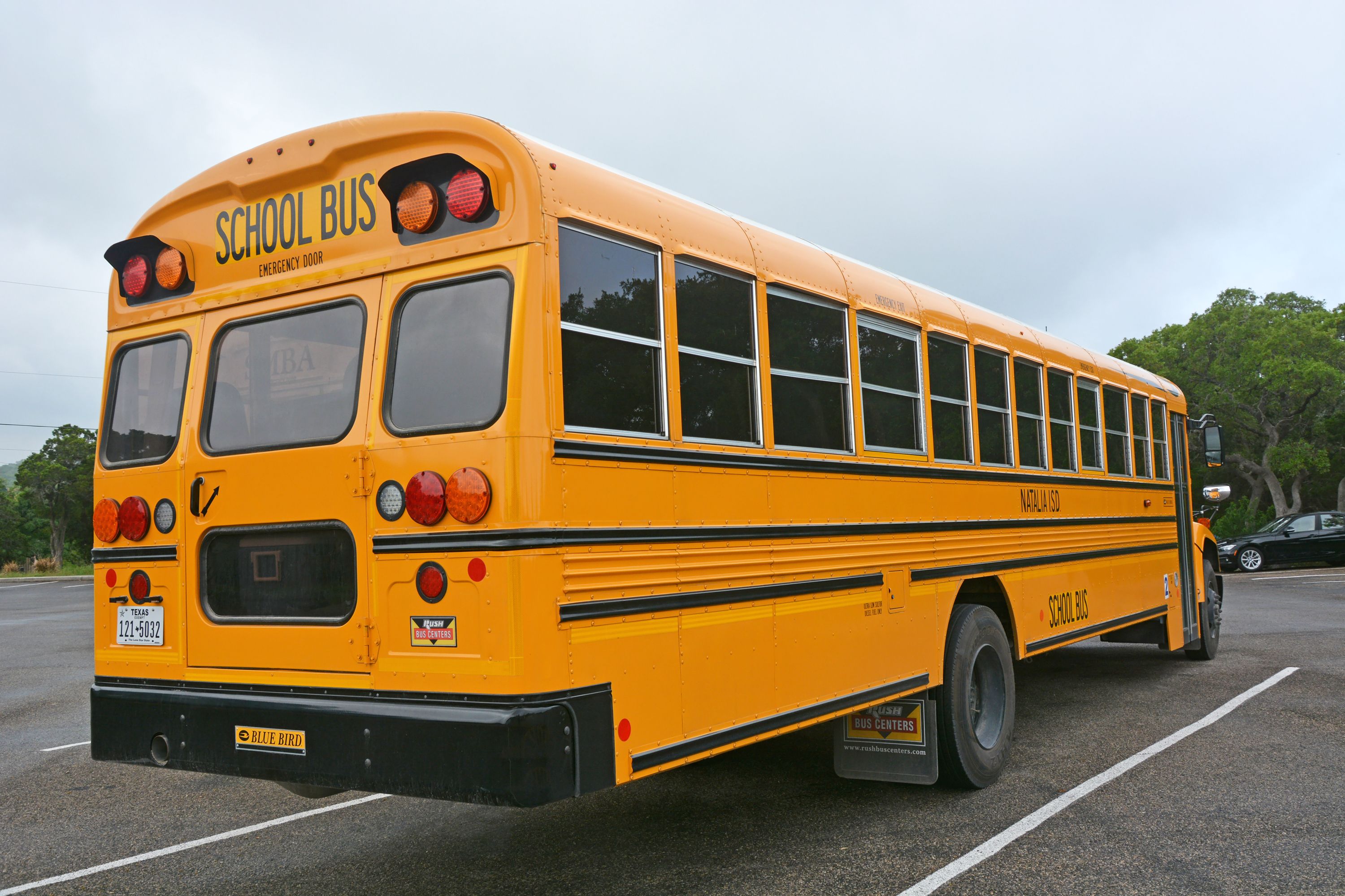 Yellow school bus at a parking lot in San Antonio, Texas. Image by Kokoulina / Shutterstock. United States, 2016.