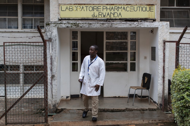 In this photo taken Thursday, Nov. 7, 2019, Richard Niwenshuti Gatera, a pharmacist and director at the Pharmaceutical Laboratory of Rwanda where the country's liquid morphine is made from powder, stands outside the facility in Butare, Rwanda. While people in rich countries are dying from overuse of prescription painkillers, people in Rwanda and other poor countries are suffering from a lack of them, but Rwanda has come up with a solution to its pain crisis - it's morphine, which costs just pennies to produce and is delivered to households across the country by public health workers. Image by Ben Curtis / AP Photo. Rwanda, 2019.