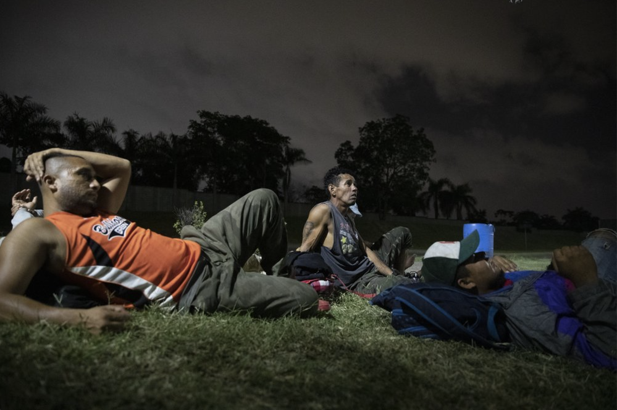 Hondurans deported from Mexico rest near a bus terminal in San Pedro Sula, Honduras, on Nov. 28, 2019, waiting for transportation to continue the trip back to their communities. The Trump Administration insists that Central Americans in danger already have safe havens. "For those of you who have legitimate asylum claims, we encourage them to go and seek assistance from the first neighboring country," Acting Customs and Border Protection Commissioner Mark Morgan recently told reporters. Image by Moises Castillo/ AP Photo. Honduras, 2019.