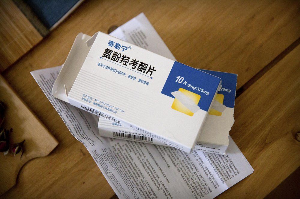 In this March 28, 2019, photo, boxes of Tylox pills Yin Hao, who also goes by Yin Qiang, earlier purchased illicitly sit on a table at a tea house in Xi'an, northwestern China's Shaanxi Province. Officially, pain pill abuse is an American problem, not a Chinese one. But people in China have fallen into opioid abuse the same way many Americans did, through a doctor's prescription. And despite China's strict regulations, online trafficking networks, which facilitated the spread of opioids in the U.S., also exist in China. Image by Mark Schiefelbein/ AP Photo. China, 2019.