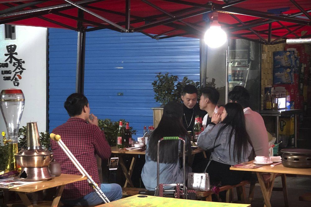 In this Dec. 6, 2019 photo, Wu Yi, who has struggled with Oxycontin abuse, sings a song for customers at an all-night restaurant in Shenzhen in southern China's Guangdong Province. Officially, pain pill abuse is an American problem, not a Chinese one. But people in China have fallen into opioid abuse the same way many Americans did, through a doctor's prescription. And despite China's strict regulations, online trafficking networks, which facilitated the spread of opioids in the U.S., also exist in China. Image by Mark Schiefelbein/ AP Photo. China, 2019.