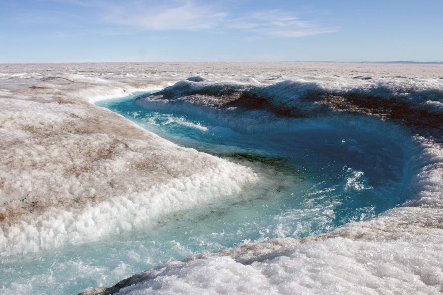 Some of the surface of the Greenland ice sheet melts every summer, forming streams, rivers and lakes that often empty into holes and fissures. This is a normal process, but as humans warm the planet, surface melt is increasing and more water is flowing off the ice sheet than is accumulating. If the entire ice sheet melted, it would cause sea level to rise roughly 23 feet, inundating coastal areas around the world. Image by Amy Martin. Greenland, 2018.