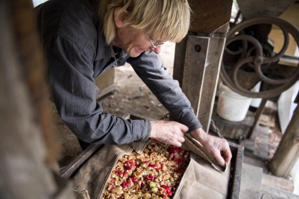 Duane Hanson presses his homegrown apples into cider at his homestead in T5 R7 in the Unorganized Territories on Sept. 17, 2019. Image by Michael G. Seamans. United States, 2019.