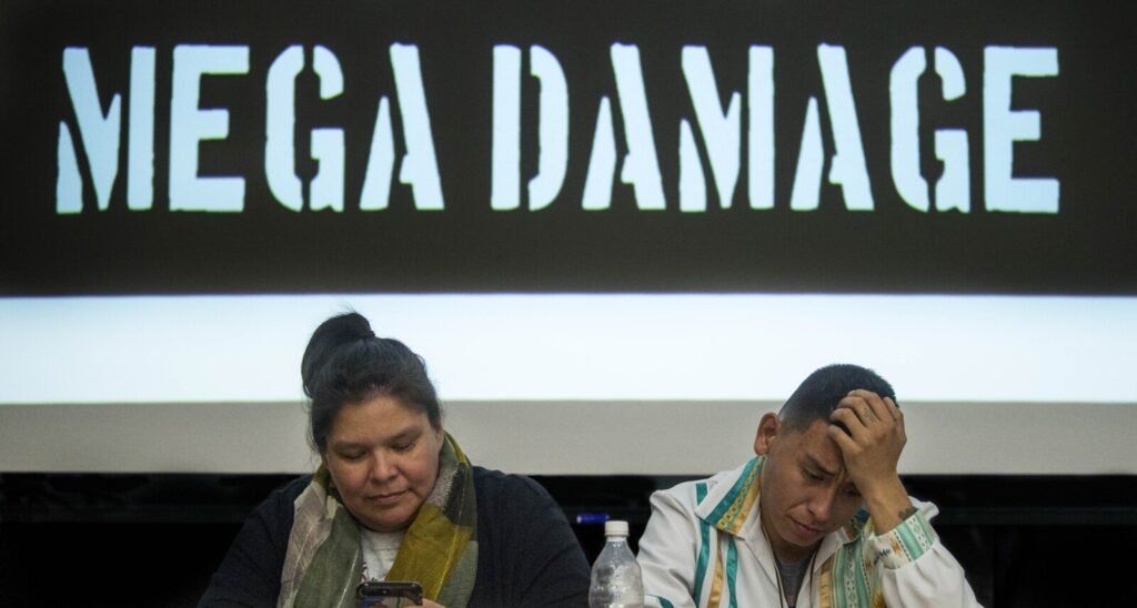 Loretta Miswaggon, left, and Carlton Richards, both of Pimicikamak Territory in Manitoba, Canada, prepare to talk about the impacts of "mega-dam" hydropower has had on indigenous tribes in Manitoba during a speaking tour at Preble Hall at the University of Maine in Farmington on Nov. 25, 2019. Image by Michael G. Seamans. United States, 2019.