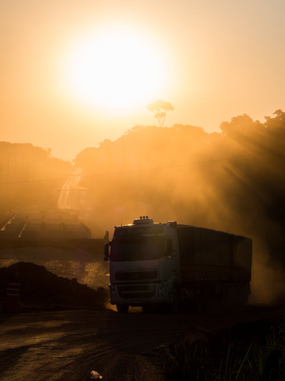 A truck filled with soy travels over an unpaved section of the BR-163 highway near the Tapajós River. Image by Heriberto Araújo. Brazil, 2019.