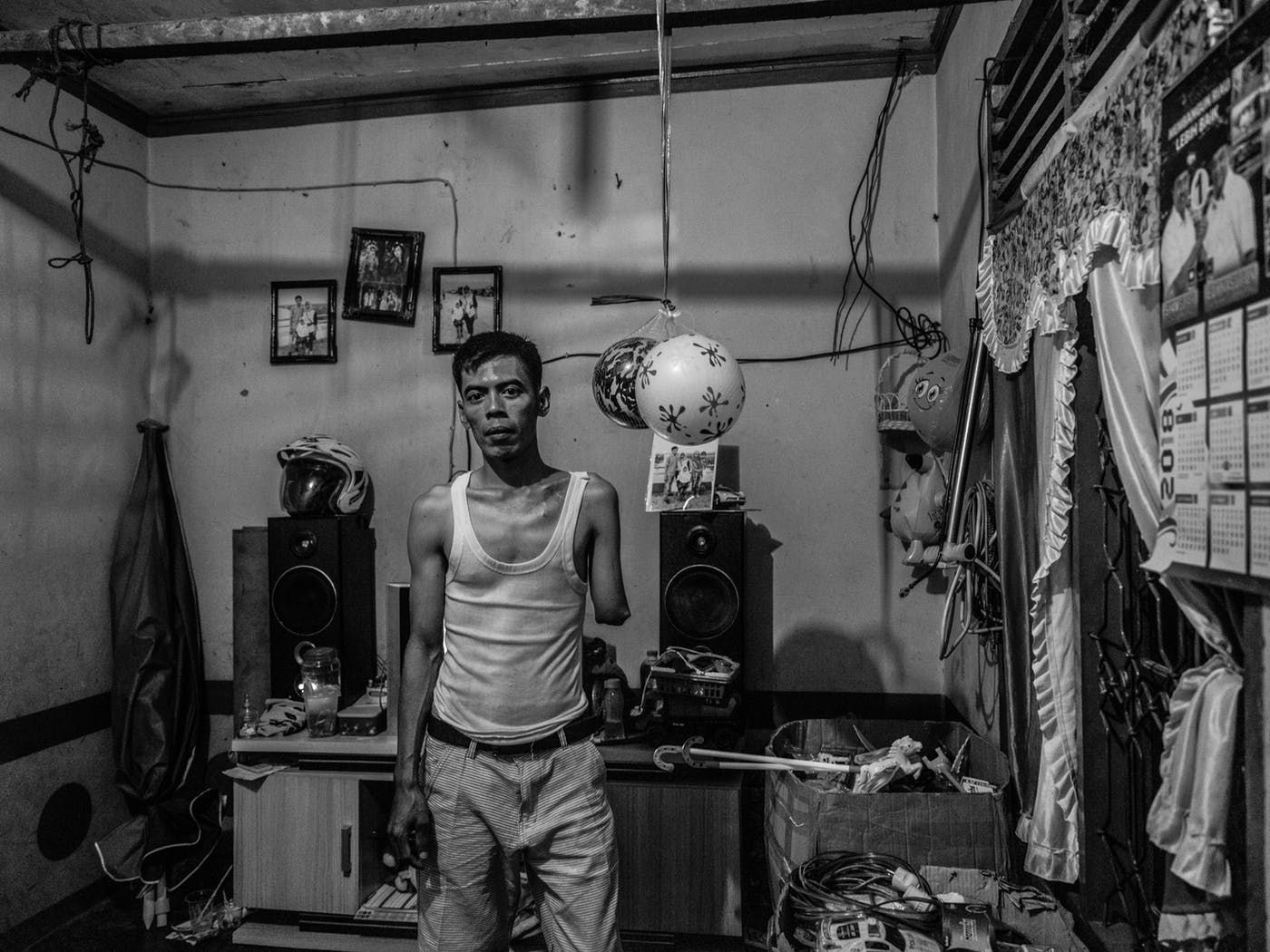 Misnan at home with the toys he sells around the village, which earn him only about $4.75 a week. Image by Xyza Cruz Bacani. Indonesia, 2018.