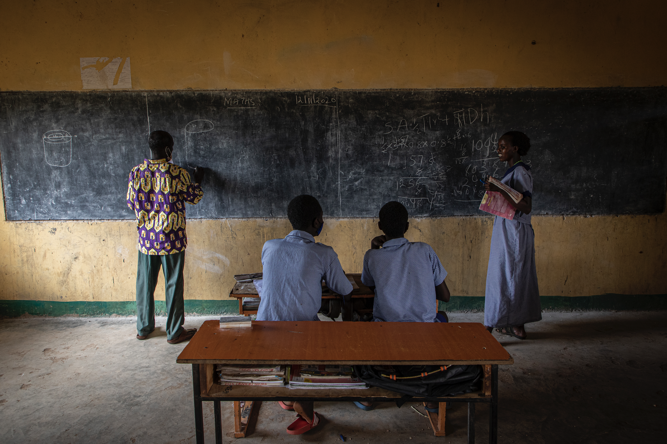 Edward Lekapana, left, teaches at a school in Laisamis, Kenya. “Some come back. They don’t concentrate the way they were concentrating before. There are some who are married off. Those who are do not return to school after they're married,” he said. Image by Will Swanson. Kenya, 2020.
