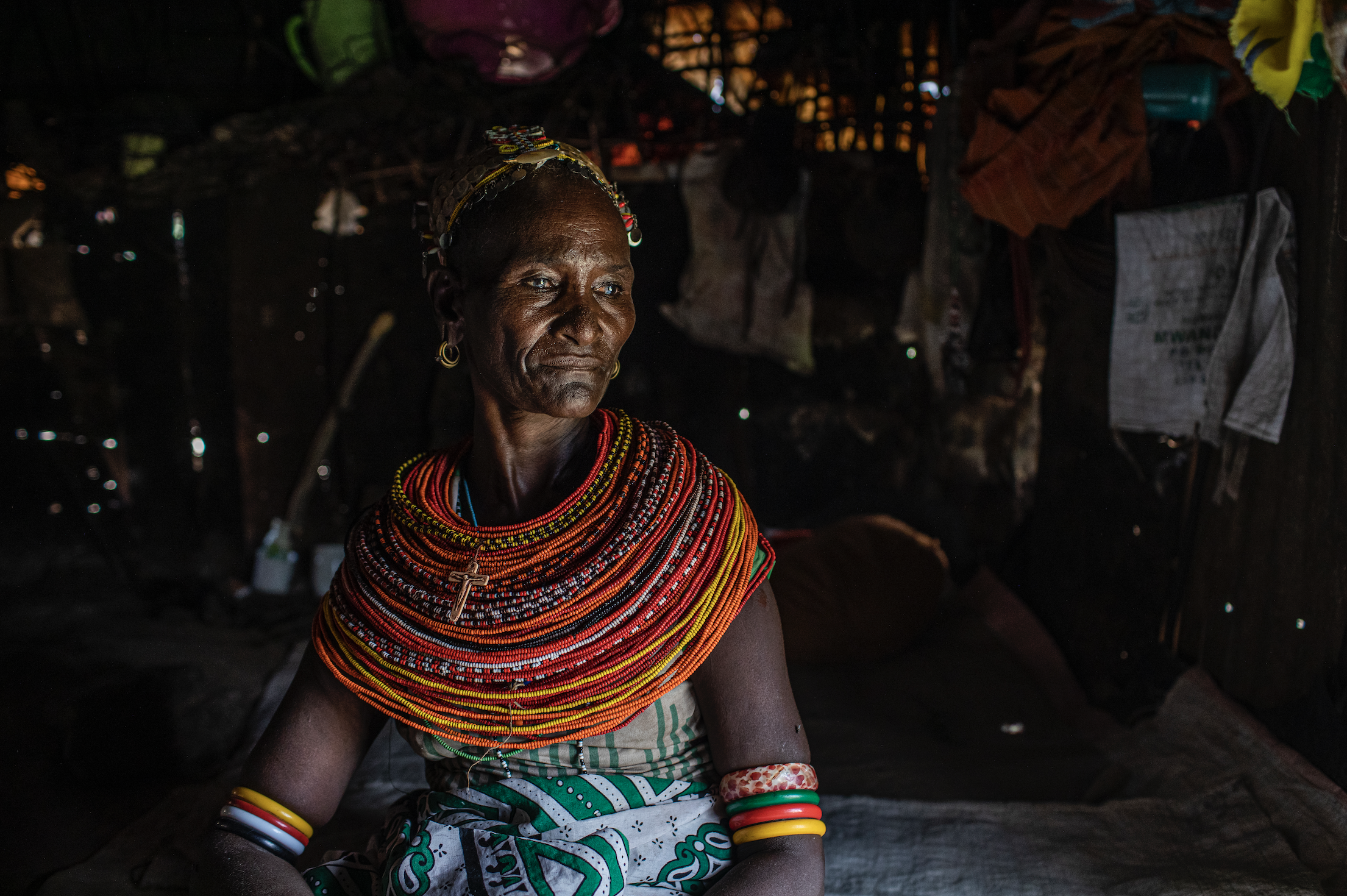 Christine Lemowonapi, a former Rendille circumciser, sits inside her home in Merille, Kenya. She has lost her source of income since the government outlawed the practice. Image by Will Swanson. Kenya, 2020.