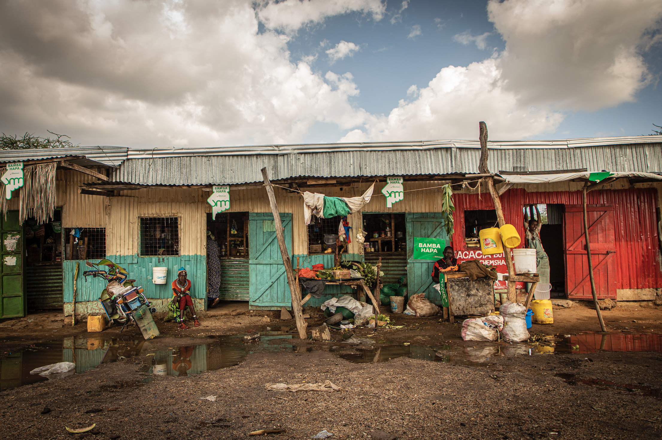 Traders and locals sit outside their stores in the Rendille town of Merille in Kenya. Image by Will Swanson. Kenya, 2020.