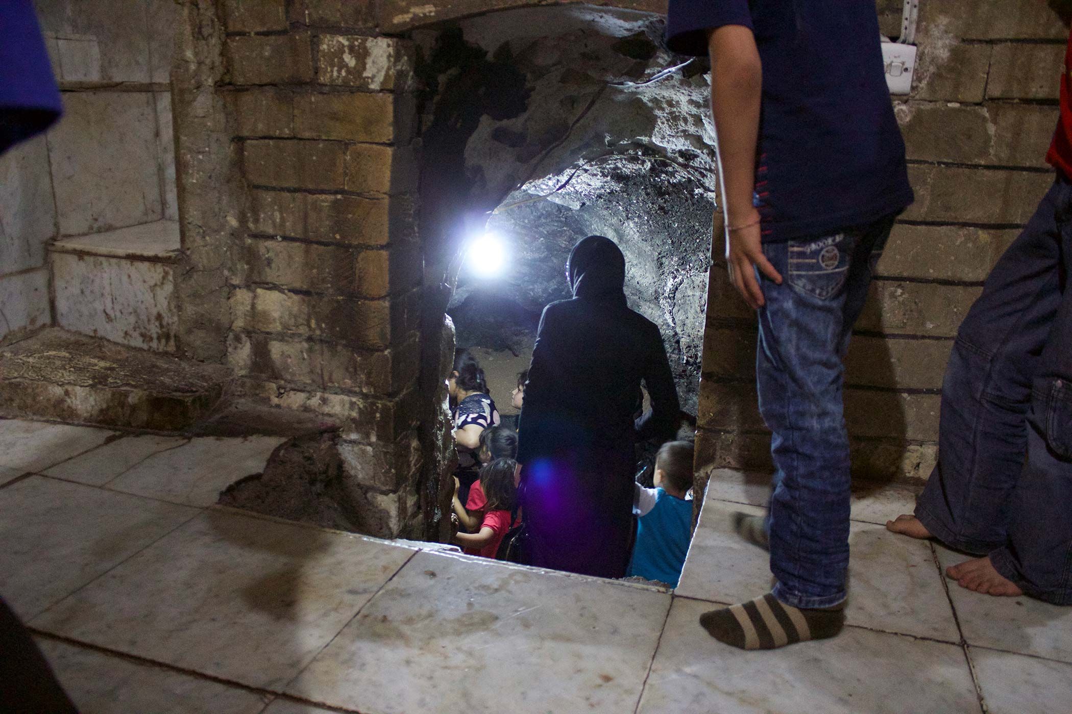 Participants in the refugee program descended a stairwell in the Yazidi sanctuary at Lalish to access a spring of holy water. Image by Emily Feldman. Iraq, 2015.