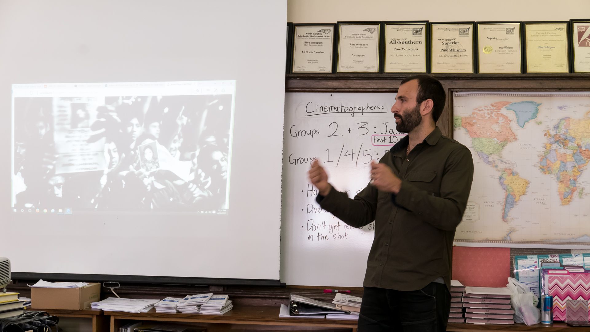 Pulitzer Center grantee Jason Motlagh describes how he reported on the collapse of the Rana Plaza textile factory in Bangladesh for journalism students at RJ Reynolds High School. Motlagh visited over 700 students in Winston-Salem, NC, in April 2017 as part of Pulitzer Center's NewsArts program. His presentation is featured as part of the film Weaving Connections. Image by Diana Greene. United States, 2017.