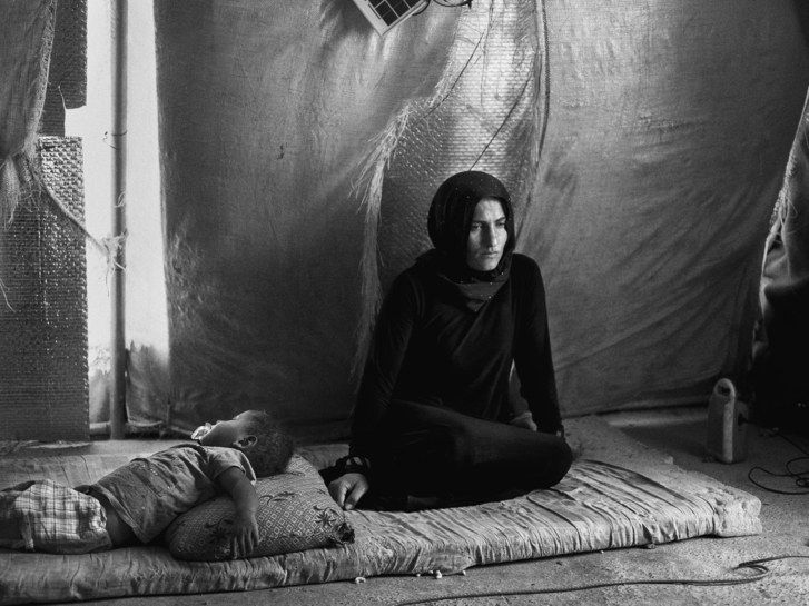 The widows of ISIS fighters often have to flee their towns, for fear of retribution. They end up in camps, where many are harassed and raped by armed men. Image by Moises Saman / Magnum for The New Yorker. Iraq, 2018.