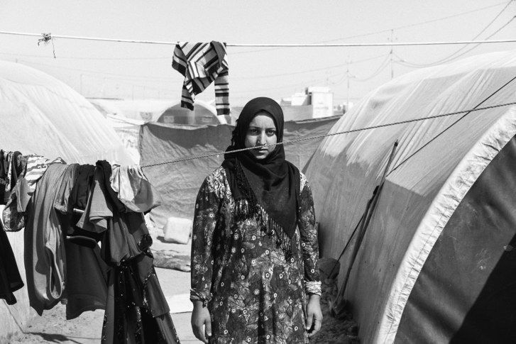 Amani wishes to leave the camp where she lives, but the government refuses to issue her an I.D. “I have not seen happiness at any moment in my life,” she said. Image by Moises Saman / Magnum for The New Yorker. Iraq, 2018.