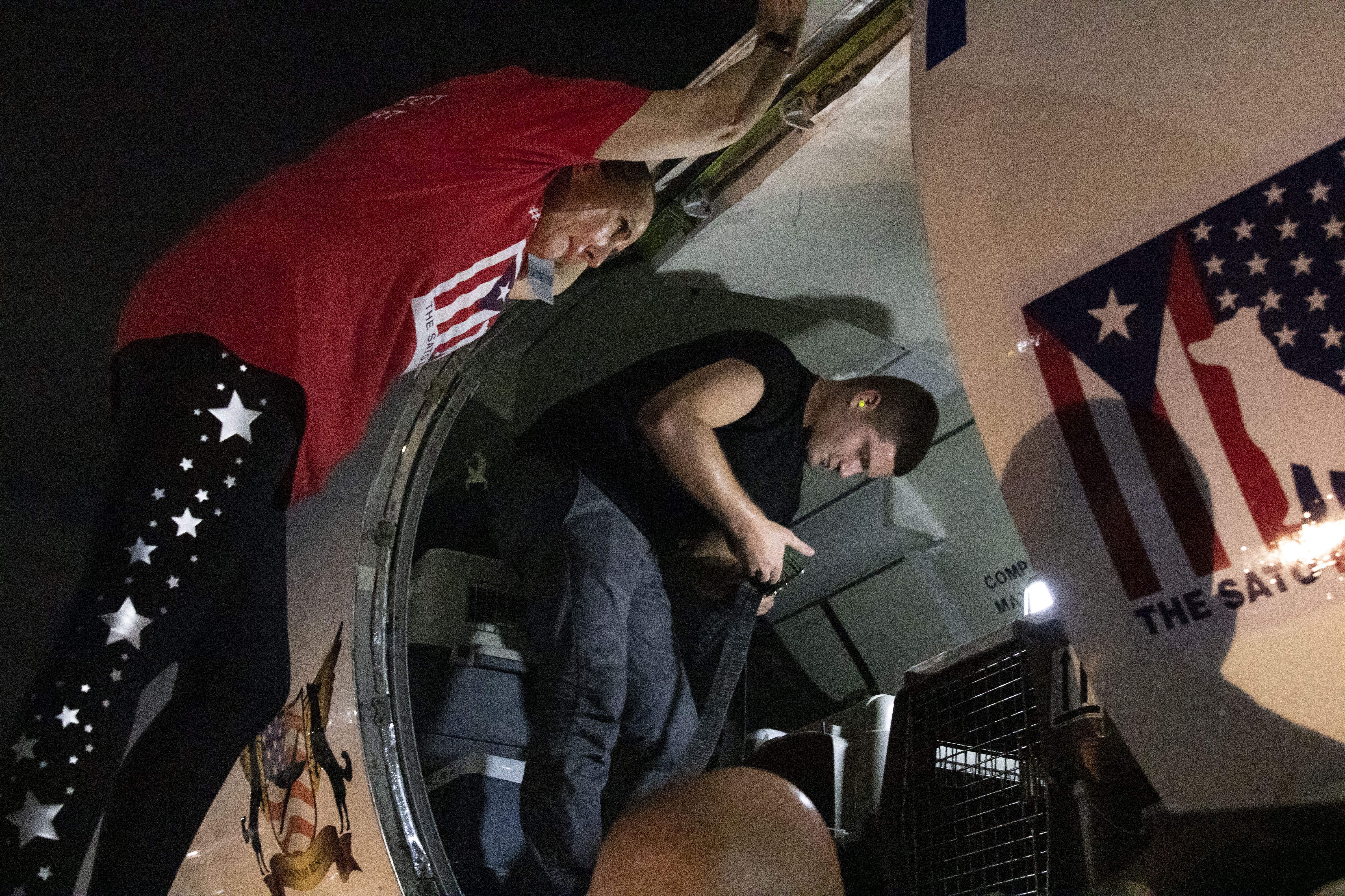 Beckles leans into the plane as the final crates are loaded in. Image by Jamie Holt. United States, 2019.
