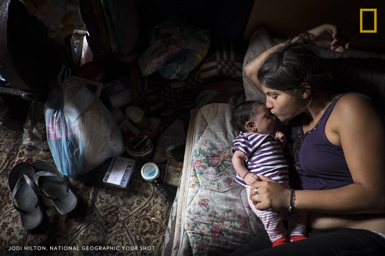 Fljurija Katunari, 18, cares for her two-month-old daughter in a shack without water or electricity on the outskirts of Belgrade, Serbia. Neither she nor her husband have any formal employment. Tens of thousands of Roma people were displaced by the war in Kosovo, including Fljurija’s family, and settled in Serbia. Seventeen years later, many still lack the documents, including a simple ID card, that would entitle them to social benefits, health care, and the right to work. Image by Jodi Hilton. Serbia.
