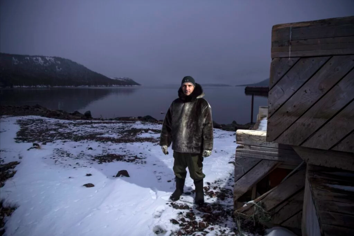 Karl Michelin poses for a portrait at the water's edge of Lake Melville in Rigolet wearing a dickie made of seal skin from a seal he hunted from the bay on Nov. 13, 2019. Image by Michael G. Seamans. Canada, 2019.
