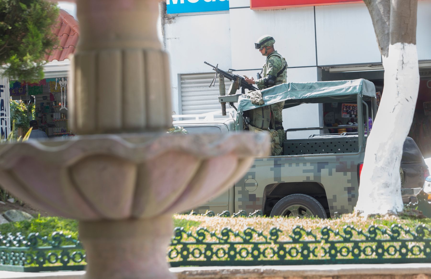 Members of the military are stationed along Chilapa’s main square. In 2017, the county of Chilapa had the second-highest homicide rate in Mexico, according to a Mexico City-based advocacy group. Image by Omar Ornelas/The Desert Sun. Mexico, 2019.