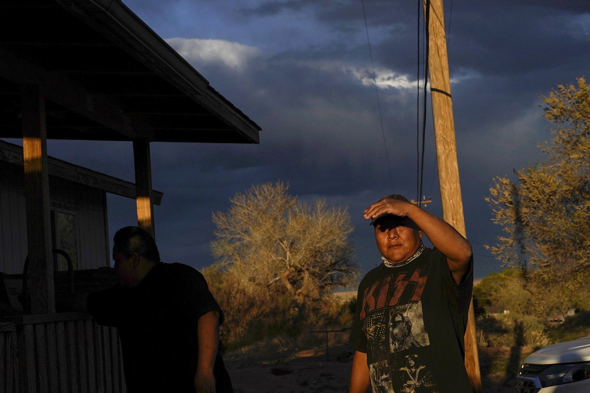 Eugene Dinehdeal shields his face from the setting sun on the Dinehdeal family compound in Tuba City, Ariz., on the Navajo reservation on April 20, 2020. The Navajo reservation has some of the highest rates of coronavirus in the country. Image by AP Photo/Carolyn Kaster. United States, 2020.