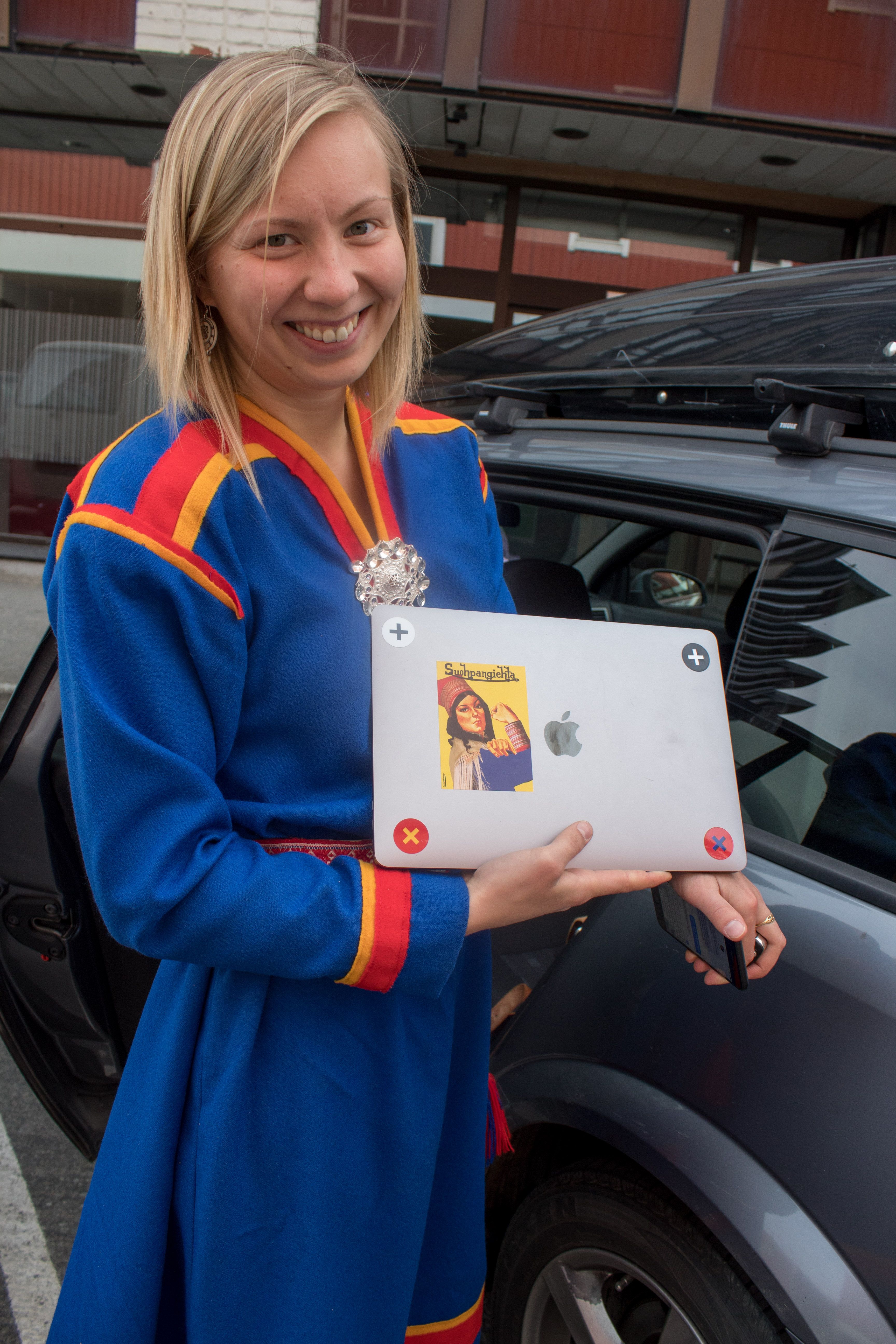 At 24, Anne Henriette Reinås Nilut is the youngest member of the Sámi Parliament of Norway. “People think that Indigenous people and Sámi people are something we read about in a history book,” she says. “But it's not." To make her point, she shows off her MacBook laptop bearing a sticker with a Sámi version of Rosie the Riveter. Image by Amy Martin. Norway, 2018.