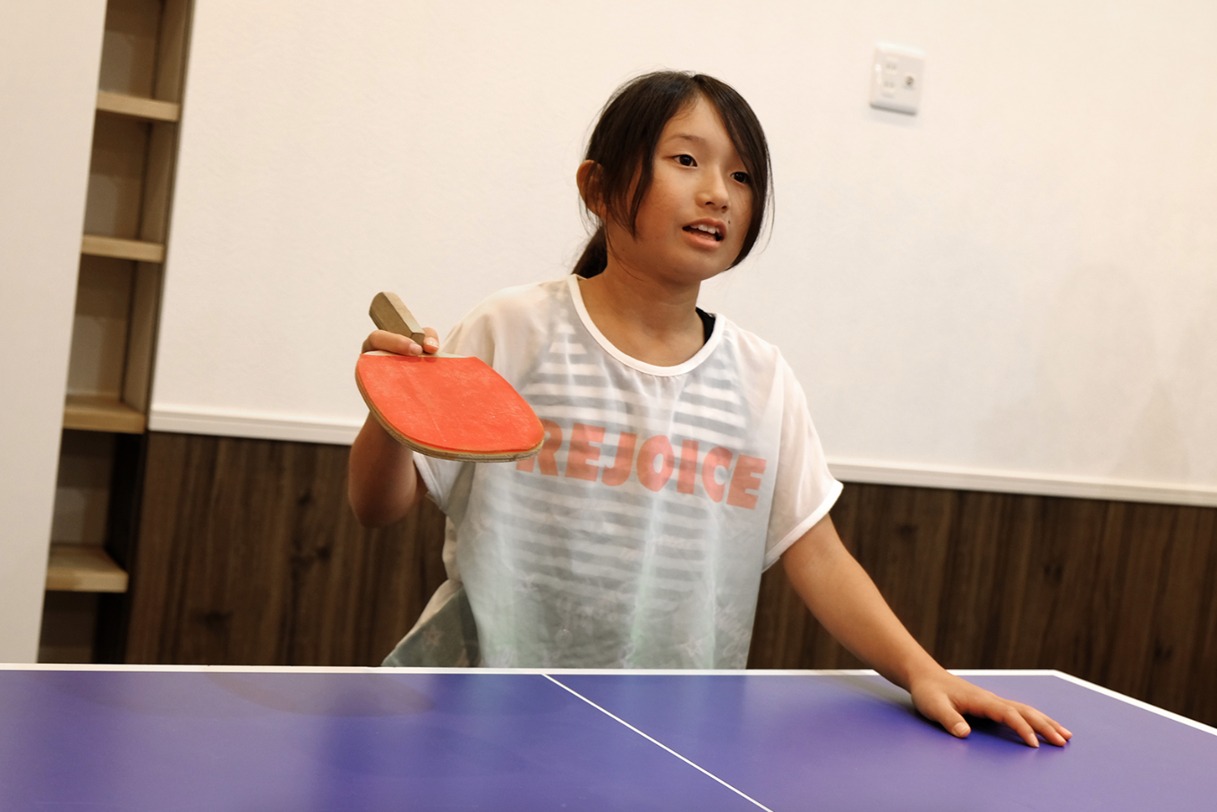 The Osakas' daughter prepares to play against her brother. Image by Emiko Jozuka. Japan, 2018.