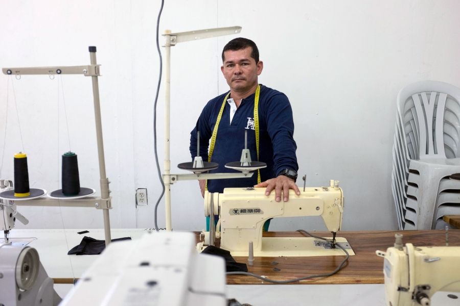 Diosenel Criado used to sew thousands of uniforms for FARC fighters during the war as an insurgent. Now he teaches ex-combatants to sew so they can make a new living.  Image by Fabio Cuttica/The World. Colombia, 2018.