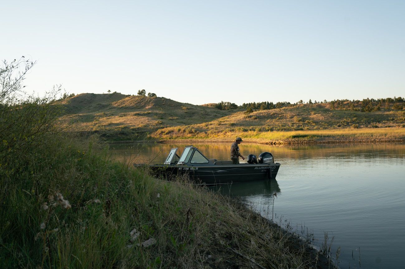 Schaaf starts his boat to head home after scouting for elk. Image by Claire Harbage / NPR. United States, 2019.