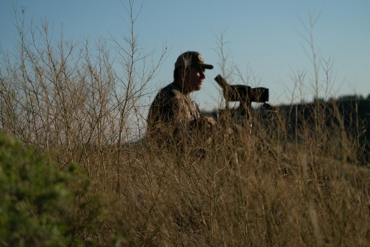 Hunter Justin Schaaf looks through a spotting scope on public lands that are part of the American Prairie Reserve, a sprawling wildlife sanctuary in northeastern Montana. Image by Claire Harbage. United States, 2019.