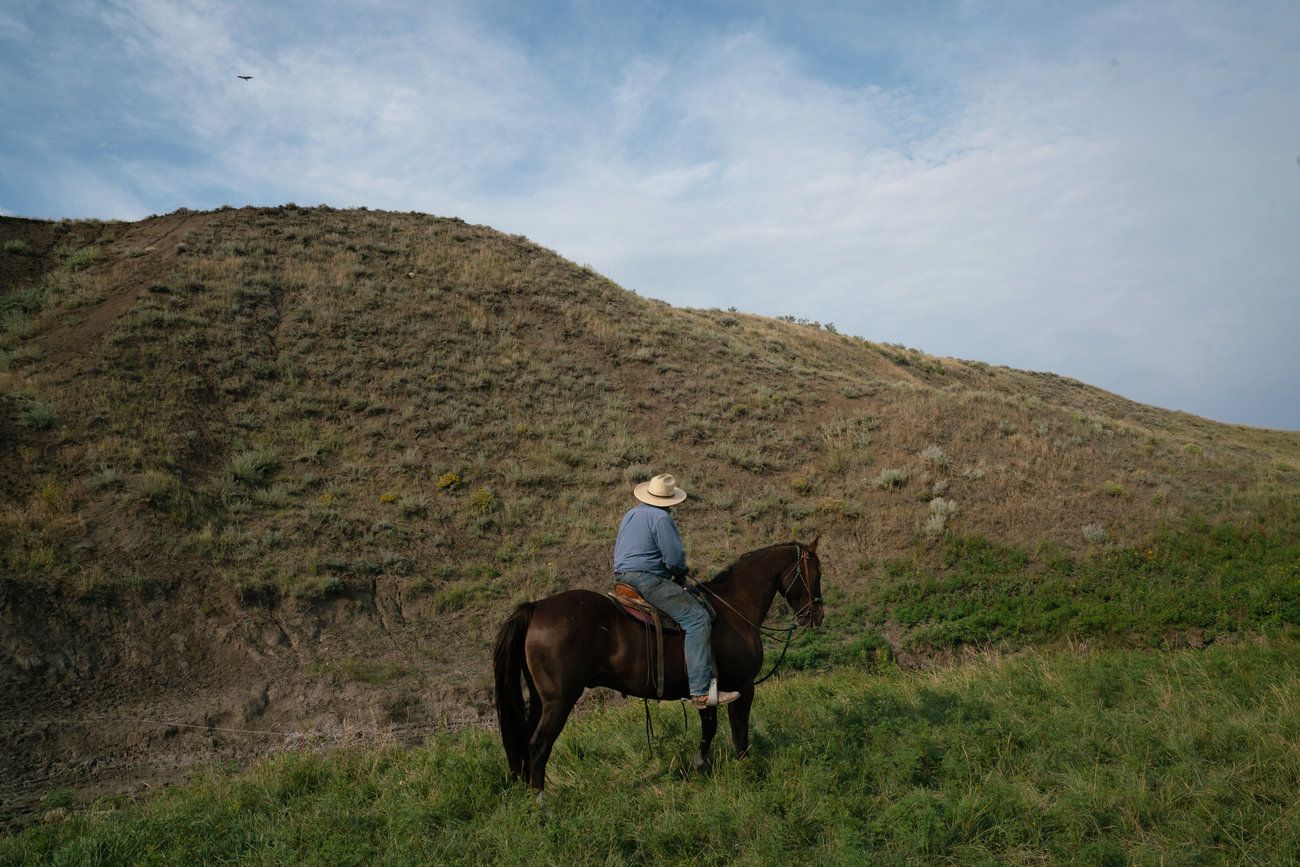 Craig French rides a horse on his ranchland. While some ranchers in this pocket of the Great Plains overgrazed their spreads and plowed up native grasses, most did a good job taking care of it. Image by Claire Harbage / NPR. United States, 2019.