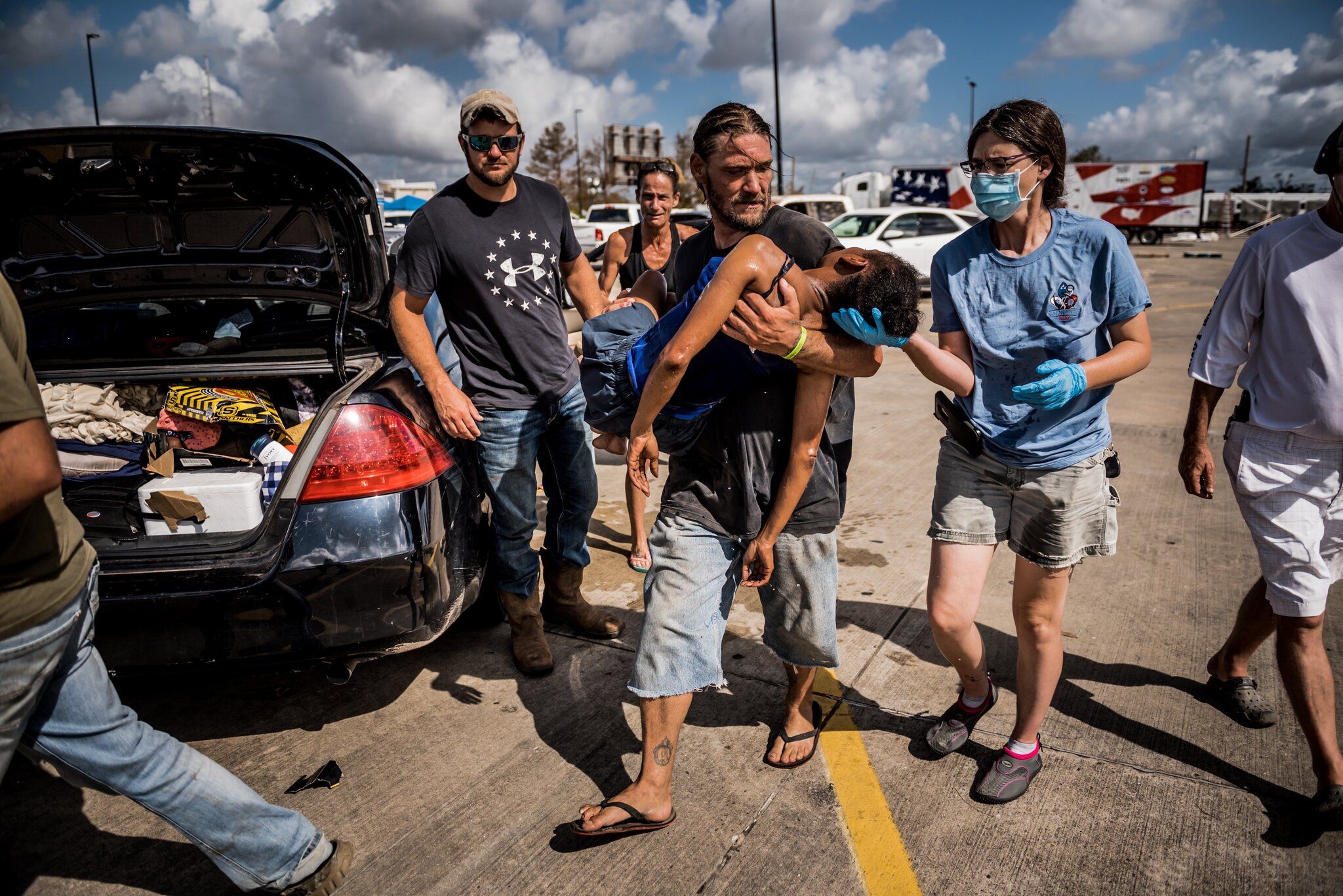 LAKE CHARLES, LA. A woman lost consciousness in a parking lot after Hurricane Laura left her without electricity or air-conditioning for several days. Image by Meridith Kohut. United States, 2020.