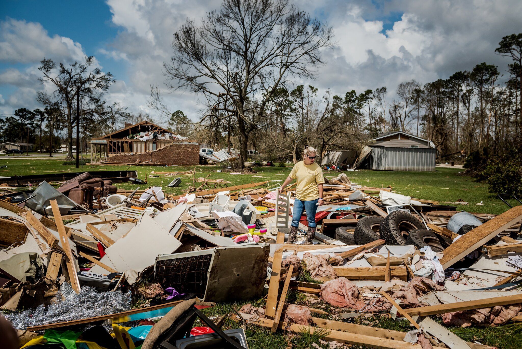 LAKE CHARLES, LA. Cassidy Plaisance surveying what was left of her friend’s home after Hurricane Laura. Image by Meridith Kohut. United States, 2020.