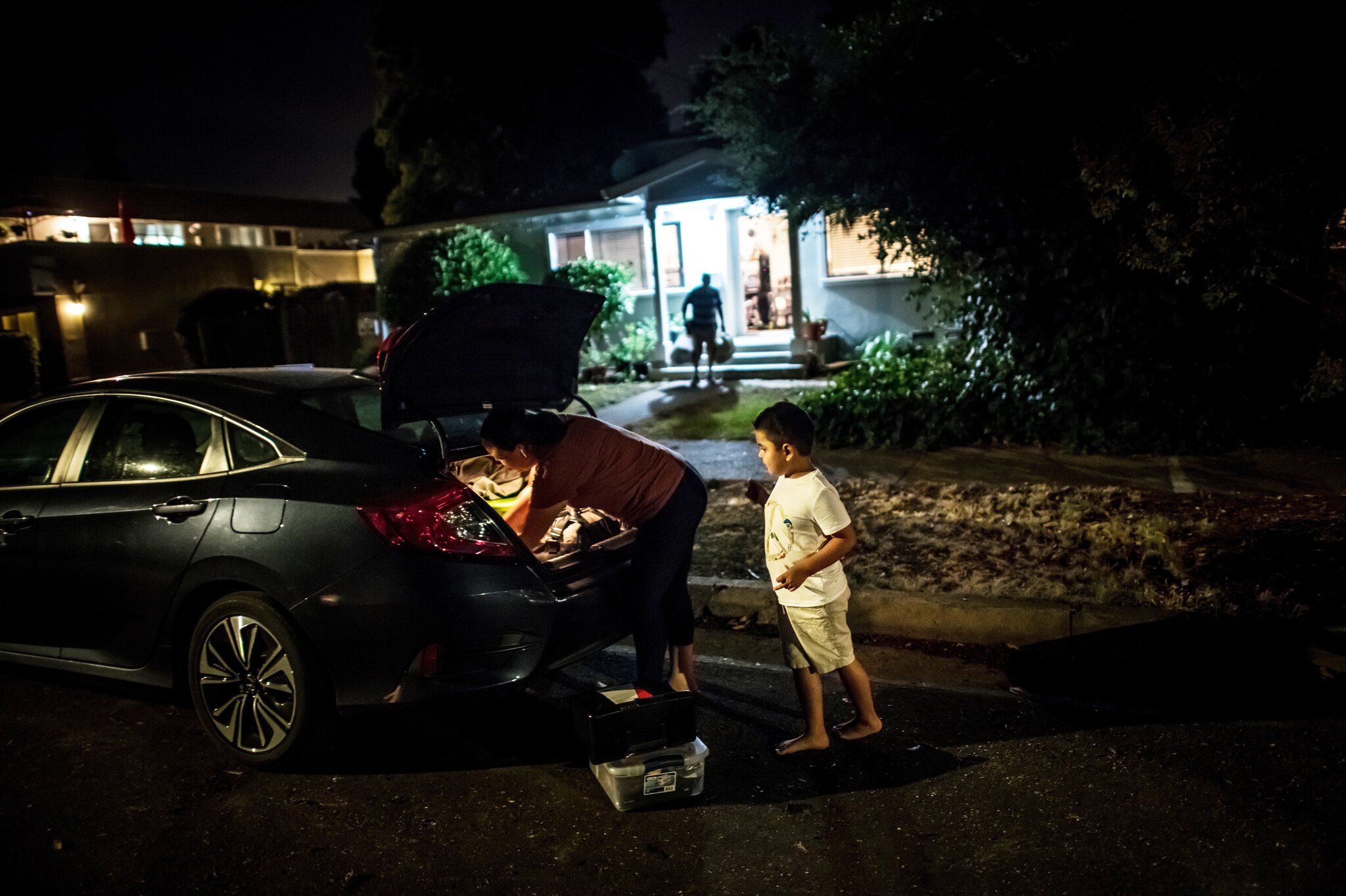SONOMA COUNTY, CALIF. Erika González and her son, Kevin, evacuating their home as the L.N.U. Lightning Complex fire approached in August. Image by Meridith Kohut. United States, 2020.