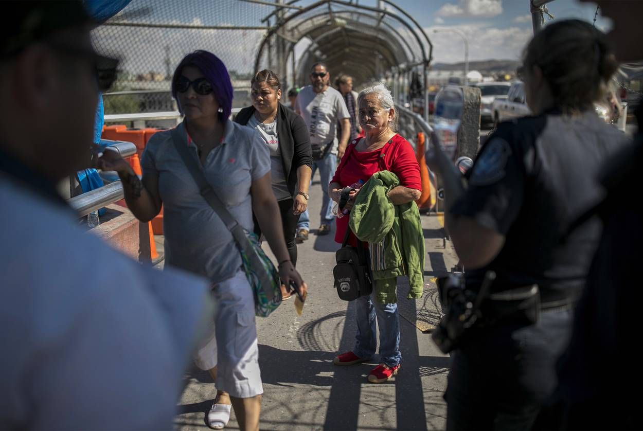A dejected Bertha Arias of Honduras looks back at her lawyer from the top of the international bridge connecting El Paso and Juárez after being denied entry into the U.S. Image by Ivan Pierre Aguirre. Mexico, 2019.