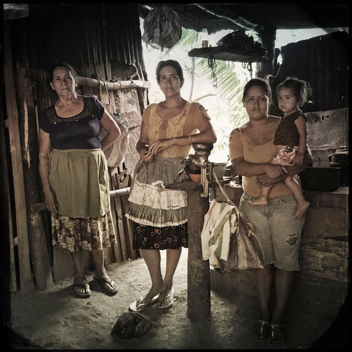Las Brisas: Four generations depend on this large cook stove in the middle of their house. Most people in this community struggle daily to find wood and provisions to operate the stoves, which are not energy efficient. Image by Lynn Johnson. Guatemala, 2017.