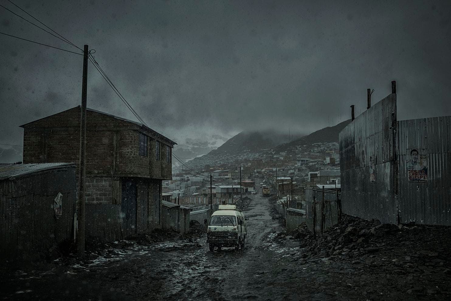 Wet snow immediately melts as it touches the ground, contributing to the muddy squalor at La Rinconada mine. Peru, 2019. Image by James Whitlow Delano.