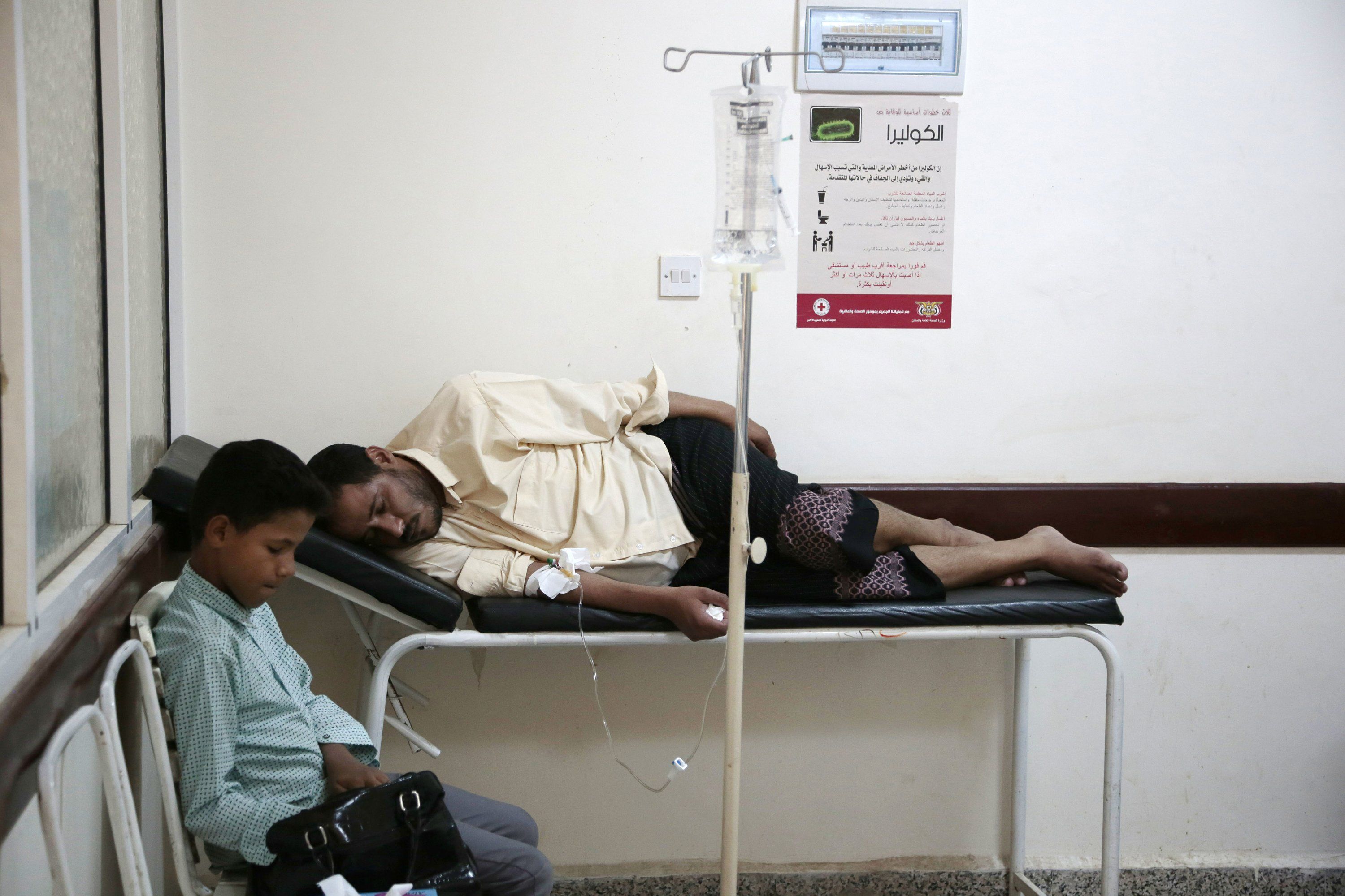 In this July 1, 2017 file photo, a man is treated for suspected cholera infection at a hospital in Sanaa, Yemen. An Associated Press investigation finds that Yemen’s massive cholera epidemic was aggravated by corruption and official intransigence. The investigation has found that both the Iranian-backed Houthis rebels and their main adversary in the war—the U.S.—and Saudi-backed government that controls southern Yemen—impeded efforts by relief groups to stem the epidemic. Image by Hani Mohamed/AP Photo. Yemen, 2017. 