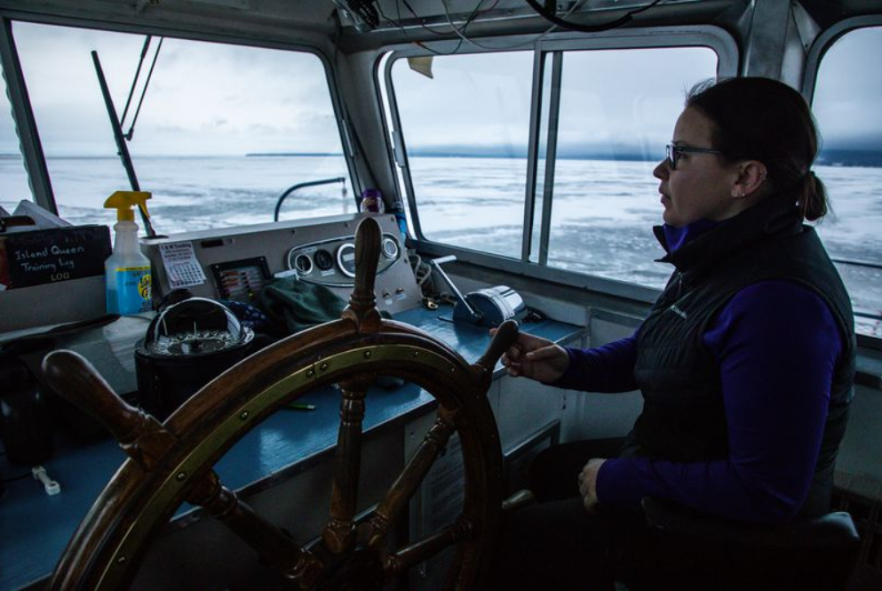 Capt. Shannon Mager steers a ferry boat through open waters of Lake Superior from Bayfield, Wisconsin, to Madeline Island on Jan. 23, 2020. Image by Zbigniew Bzdak/The Chicago Tribune. ​​​​​​​United States, 2020.