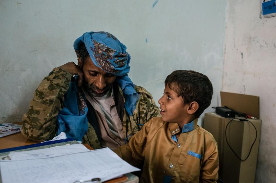 Rasheed speaks with a urologist about the possibility of a surgical fix for Mohammad's fistula. Rasheed had just enough money to make the trip to the hospital—but not enough to complete the procedure. Image by Alex Potter. Yemen, 2018.