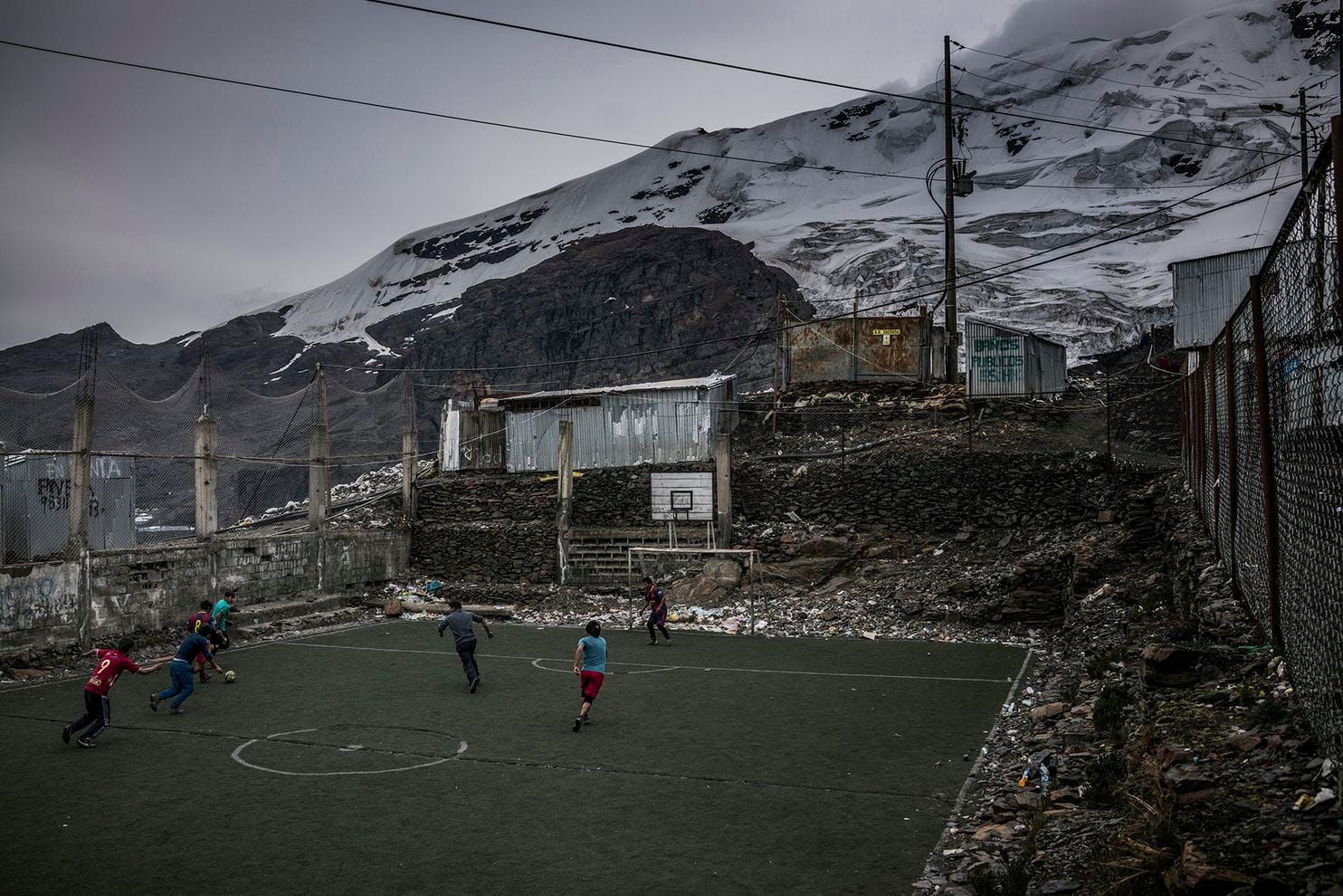 Men play soccer on artificial turf. Grass does not grow at 17,700 feet. Peru, 2019. Image by James Whitlow Delano.