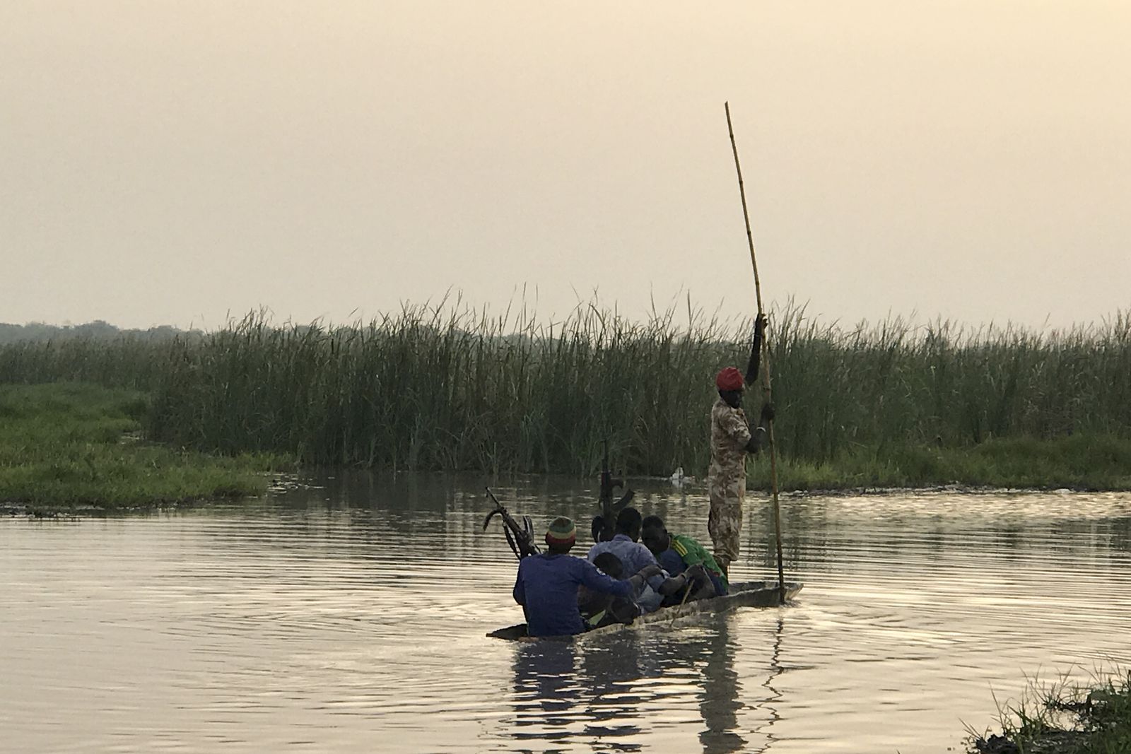 In Ganyiel village, South Sudan, rebels travel between posts on a traditional canoe. Image by Jane Ferguson. South Sudan, 2017.