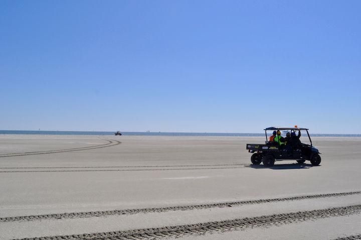 Restoration workers drive across some of the newest land in Louisiana. Nearly 16 million cubic yards of sand were pumped from the Gulf of Mexico to replenish Whiskey Island's eroded shores. Image by Tristan Baurick. United States, 2019.