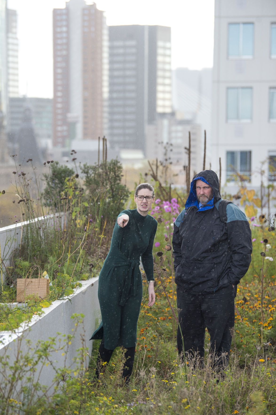 Eveline Bronswijk, left, with the city of Rotterdam, discusses a green roof that grows food for a restaurant. Image by Chris Granger. Netherlands, 2019.