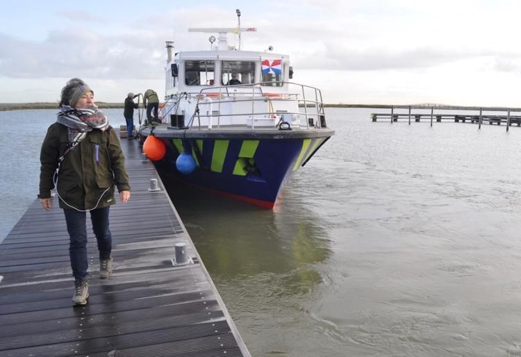 A supply boat staffed by volunteers docks at the Marker Wadden, a series of artificial islands north of Amsterdam. The islands are part of a project aimed at restoring a lake harmed by a large dam. Image by Tristan Baurick / Times-Picayune | The Advocate. The Netherlands, 2020.